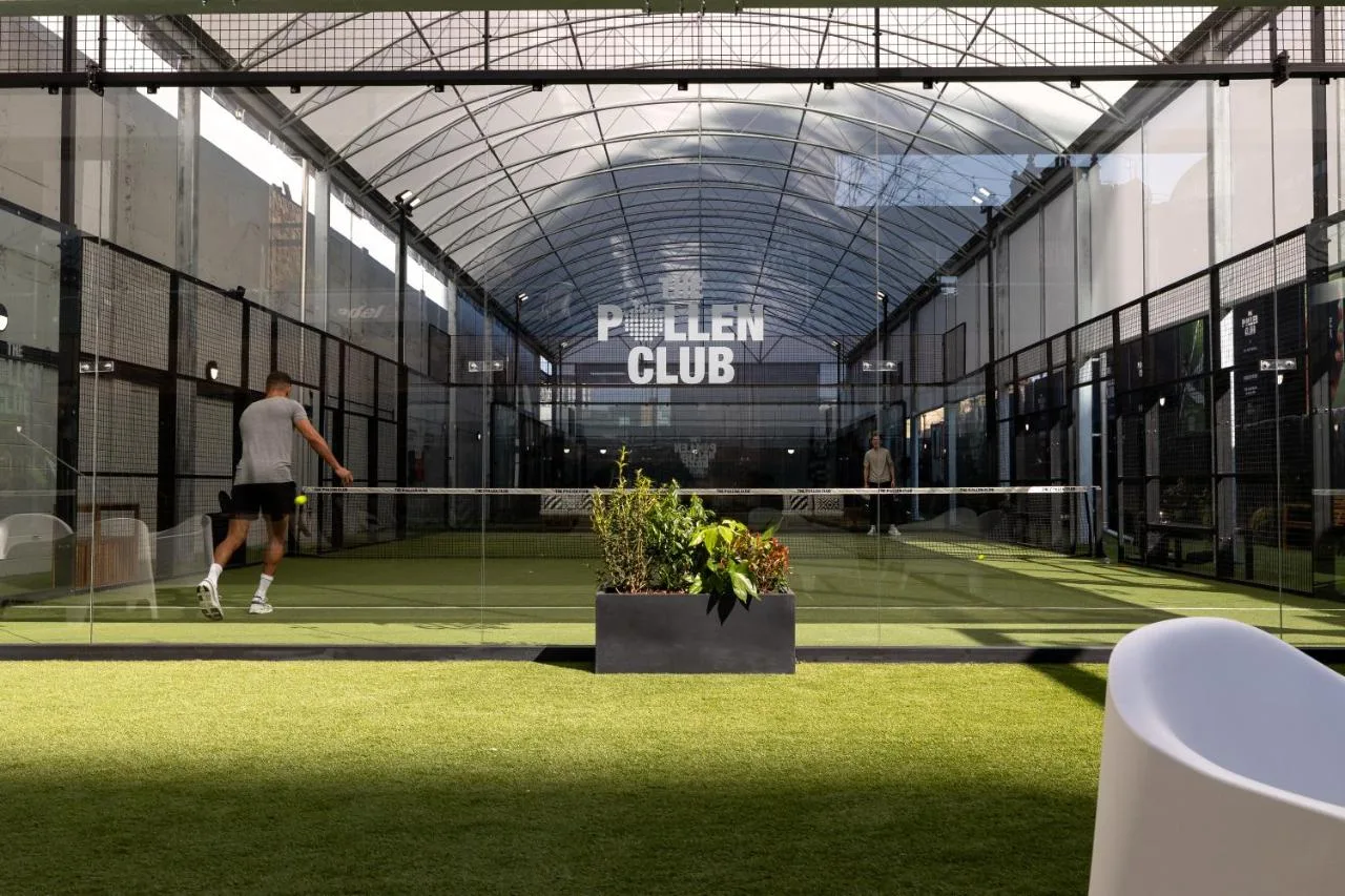 Guest playing tennis on court at Treehouse Hotel Manchester