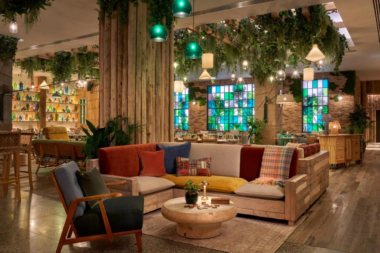 Living room style lounge with couches and chairs at Treehouse Hotel Manchester